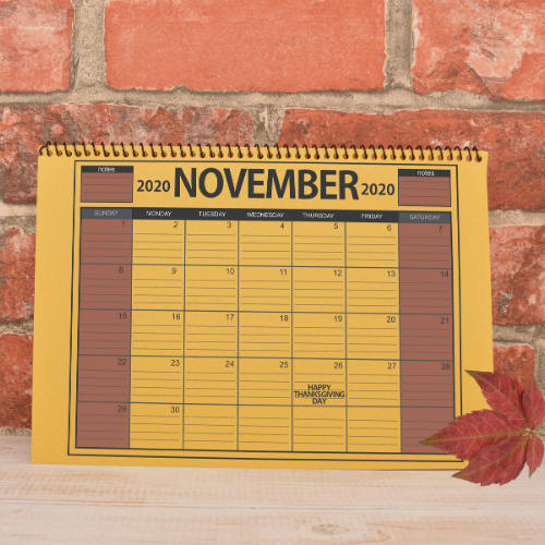 November calendar page against a brick wall