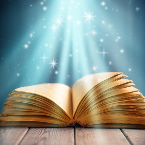 picture of open book with beam of light shining on it, suggesting magic