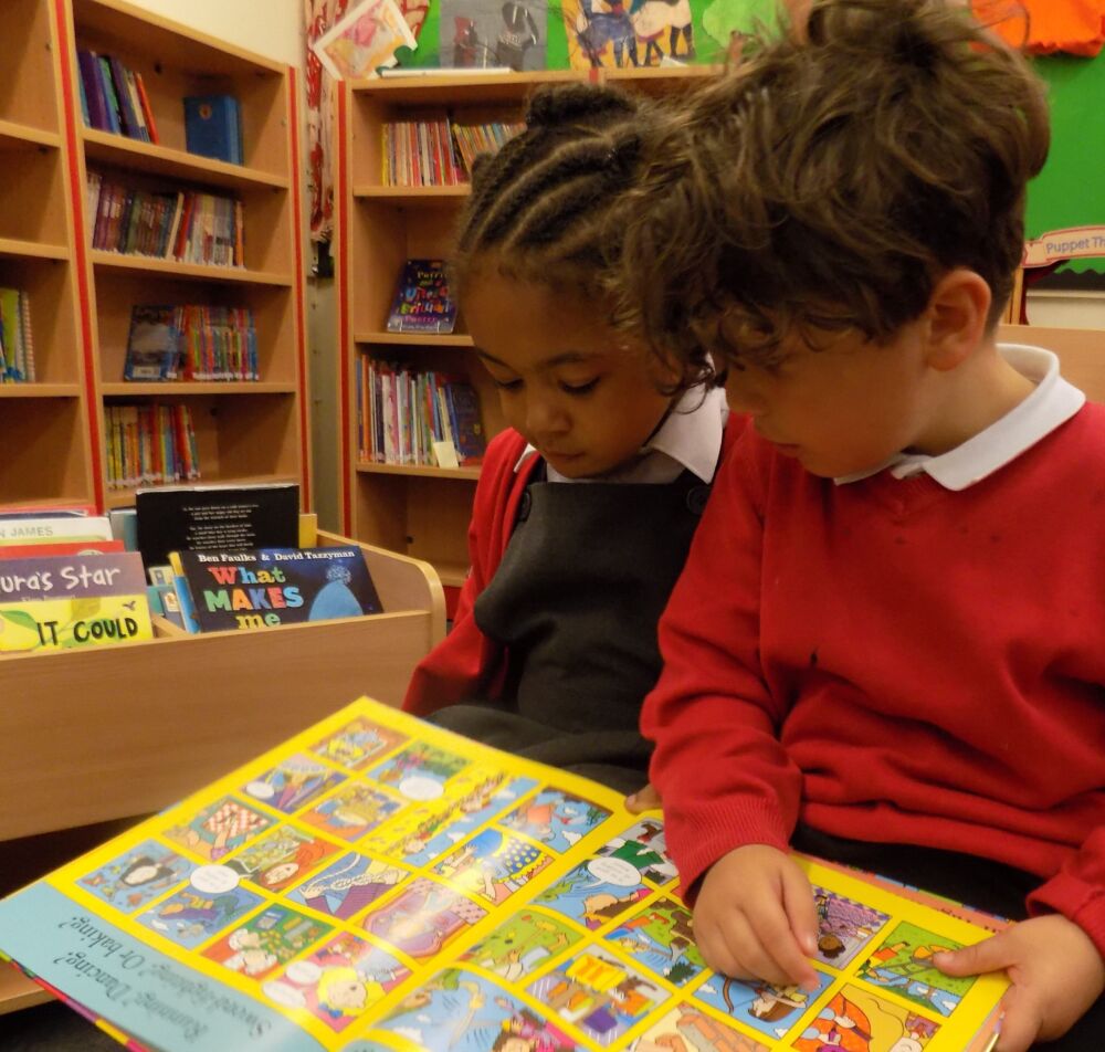 Two Reception aged children sharing a book together