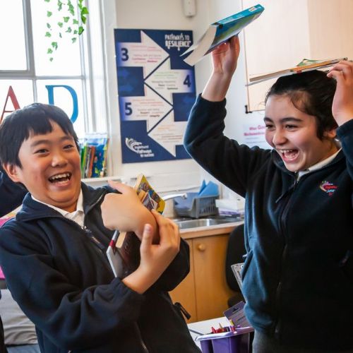 Kids laughing with books